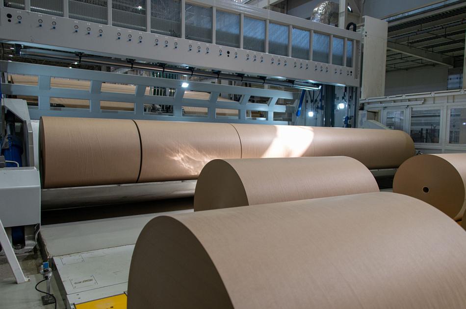 A stack of finished corrugated sheets showing the clean liner surface